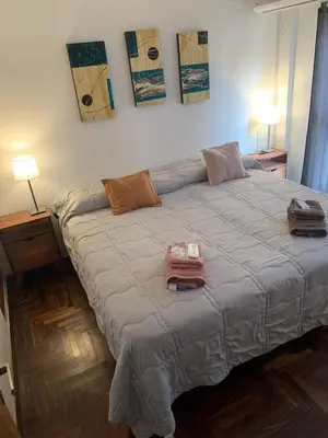 a bedroom with a large bed with two pillows on it at Departamento 100% equipado y excelente ubicación in Cordoba