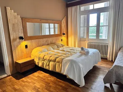 a bedroom with a bed with a teddy bear on it at Hostal de la Costa in Villa Carlos Paz