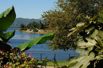 a view of a river with mountains in the background at Hostal de la Costa in Villa Carlos Paz