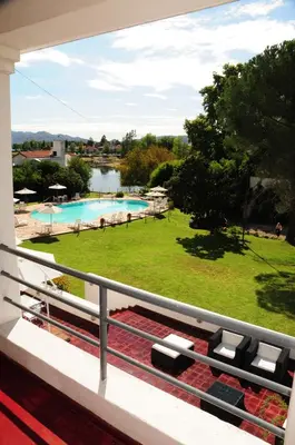 a balcony with a view of a swimming pool at Hostal de la Costa in Villa Carlos Paz