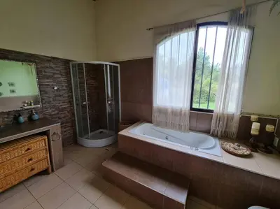 a large bathroom with a tub and a window at HERMOSA CASA con 4000mts de PARQUE en las SIERRAS DE CORDOBA in José de la Quintana