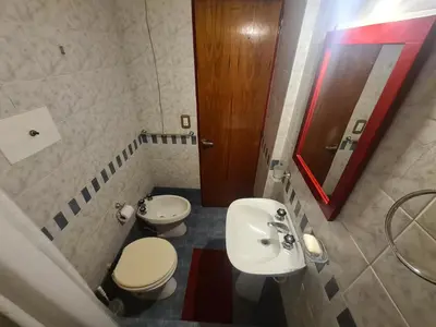 a bathroom with a sink and a toilet and a mirror at Hermoso Monoambiente en Nva Cordoba in Cordoba