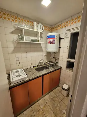 a small kitchen with a sink and a microwave at Monoambiente Centro in Cordoba