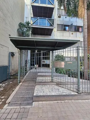 a building with a gate in front of a building at Monoambiente Centro in Cordoba