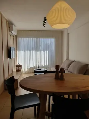 a living room with a table and a living room with a couch at Premium appart LOCADOR Nueva Cordoba14C in Cordoba