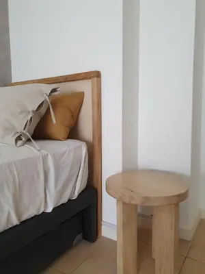 a bed with a wooden table next to a bed at Premium appart LOCADOR Nueva Cordoba14C in Cordoba