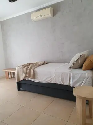 a bedroom with a bed with a air conditioner on the wall at Premium appart LOCADOR Nueva Cordoba14C in Cordoba