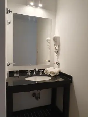a bathroom with a sink and a large mirror at Premium appart LOCADOR Nueva Cordoba14C in Cordoba