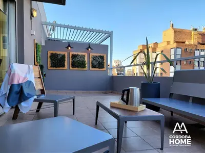 a patio with tables and chairs on a balcony at A&A Cordoba Home - Duplex Boutique en Nueva Cordoba in Cordoba