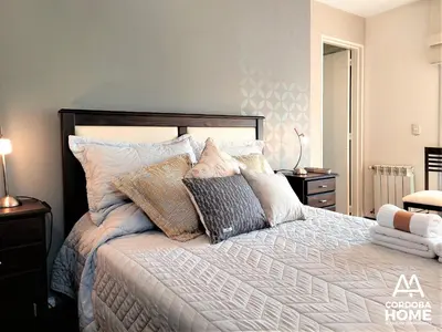 a bedroom with a large bed with many pillows at A&A Cordoba Home - Duplex Boutique en Nueva Cordoba in Cordoba
