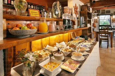 a buffet of food on a table in a restaurant at Hotel Boutique Spa & Sushi Posada de Campo-Solo adultos in Villa General Belgrano
