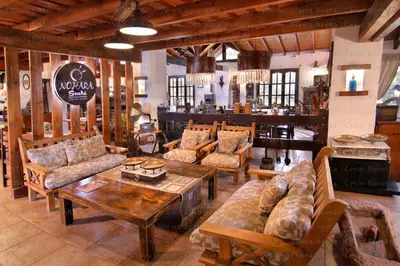 a store with couches and tables in a room at Hotel Boutique Spa & Sushi Posada de Campo-Solo adultos in Villa General Belgrano