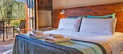 a bedroom with a bed with two towels on it at Hotel Boutique Spa & Sushi Posada de Campo-Solo adultos in Villa General Belgrano