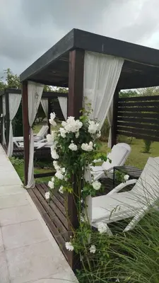 a gazebo with a bunch of white flowers at Hotel Boutique Spa & Sushi Posada de Campo-Solo adultos in Villa General Belgrano