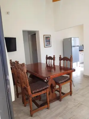 a dining room with a wooden table and chairs at Álamos de Belén in Carpintería