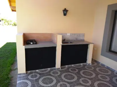a kitchen with a counter in the corner of a room at Álamos de Belén in Carpintería