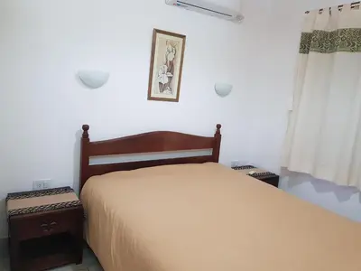 a bedroom with a bed and a window at Álamos de Belén in Carpintería
