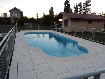 a swimming pool with a fence around it at Álamos de Belén in Carpintería
