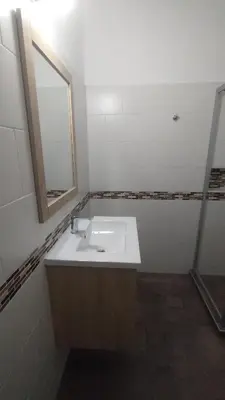 a bathroom with a white sink and a mirror at DEPARTAMENTO DIARIO PASEO DEL JOCKEY in Cordoba