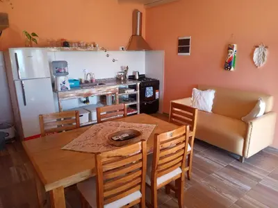 a kitchen and dining room with a table and chairs at Luz de las Sierras 2 in Arroyo de Los Patos