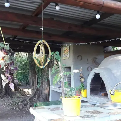 an outdoor patio with a pizza oven and a potted plant at Posada Villapancha B&B in San Javier