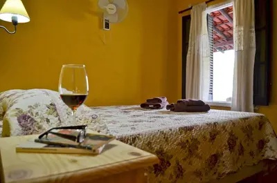a glass of wine sitting on top of a bed at Posada Villapancha B&B in San Javier