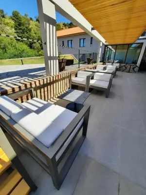 a row of benches sitting on a patio at Hotel Estilo MB - Merlo in El Rincón