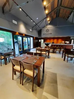 a dining room with wooden tables and chairs at Hotel Estilo MB - Merlo in El Rincón
