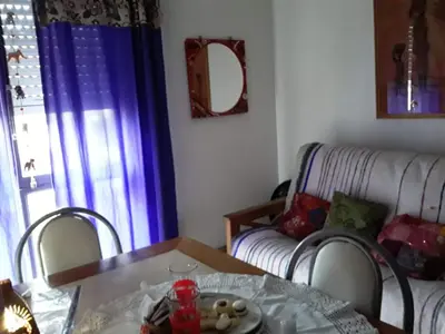 a living room with a table and a couch at Temporal Adry in Cordoba
