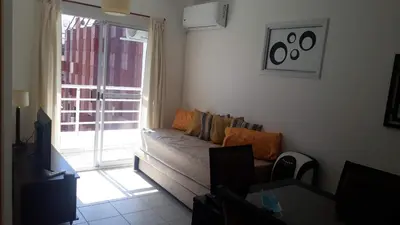 a living room with a couch and a window at Artigas in Cordoba