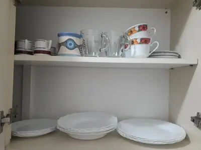 a shelf with plates and cups and dishes on it at Artigas in Cordoba