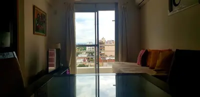 a living room with a glass table in front of a window at Artigas in Cordoba