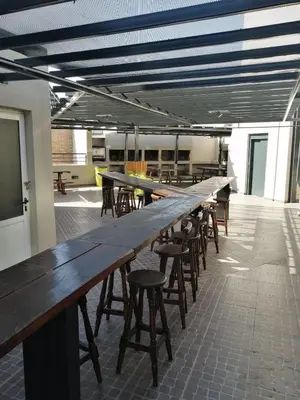 a long wooden table and chairs in a room at Punto Urbano in Villa Carlos Paz