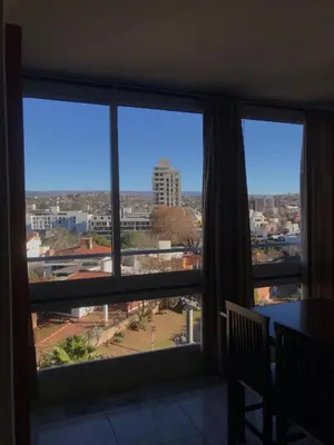 a room with a window with a view of a city at Punto Urbano in Villa Carlos Paz