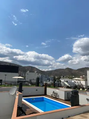 a swimming pool on the roof of a building at Punto Urbano in Villa Carlos Paz