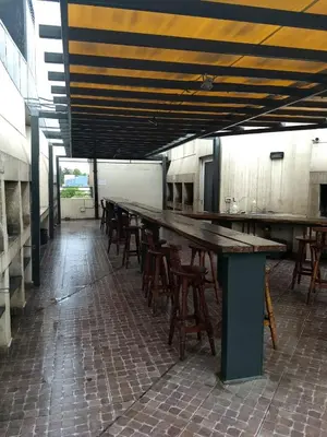 a row of tables and chairs in a kitchen at MIRALEJOS33K in Villa Carlos Paz