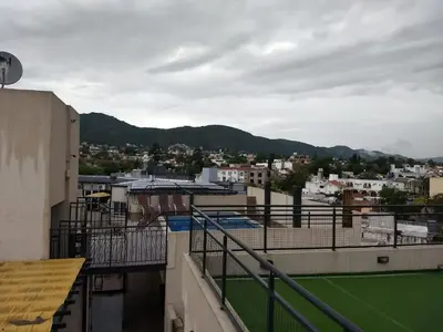 a view of a city from the balcony of a building at MIRALEJOS33K in Villa Carlos Paz