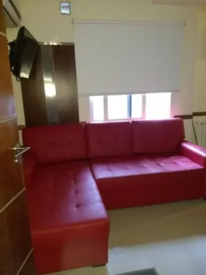 a red couch in a room with a window at MIRALEJOS33K in Villa Carlos Paz