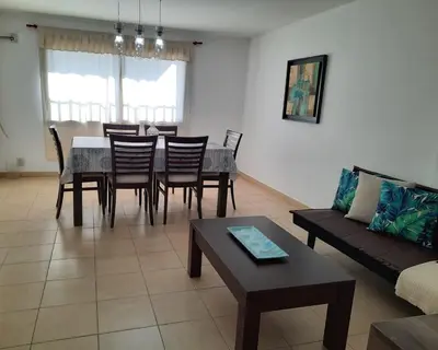 a living room with a table and chairs and a couch at Departamento en Nueva Córdoba in Cordoba