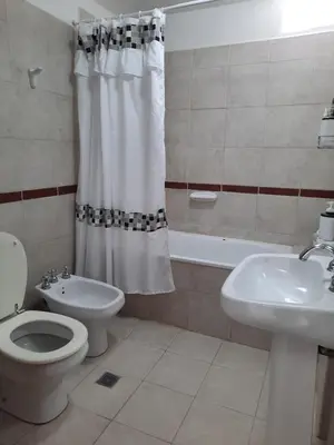 a bathroom with a toilet and a sink and a tub at Departamento en Nueva Córdoba in Cordoba