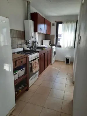 a kitchen with a sink and a stove top oven at Departamento en Nueva Córdoba in Cordoba