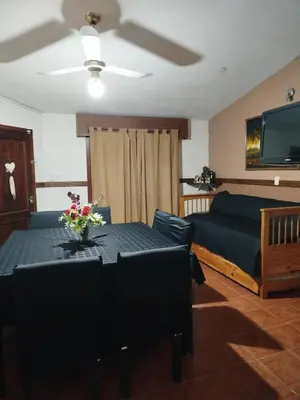 a living room with a table and a couch at Chalet 