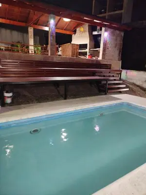 a bench sitting next to a swimming pool at Chalet 