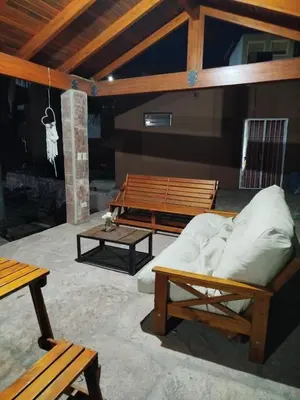 a room with benches and a bed and a table at Chalet 