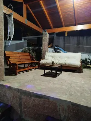 a patio with a couch and a bench and a table at Chalet 