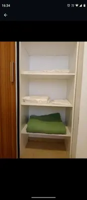 a white cabinet with a green pillow in it at Apartamentos Santa Rosa PB3 in Cordoba