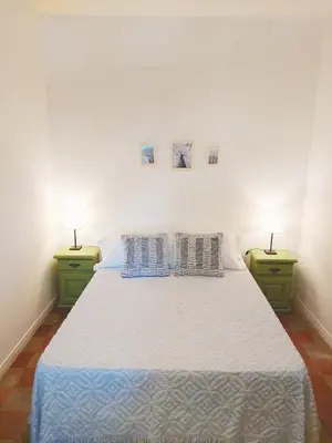 a bedroom with a large bed with two night stands at Casa Sarmiento in San Francisco del Monte de Oro
