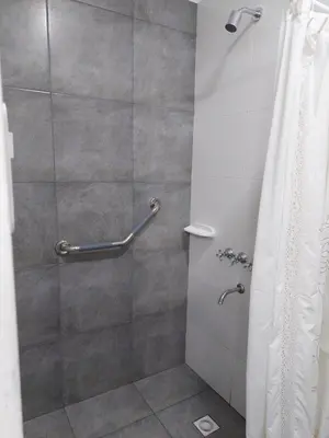 a bathroom with a shower with a shower curtain at Casa Sarmiento in San Francisco del Monte de Oro