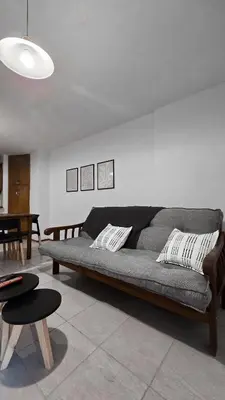 a living room with a couch and a table at CHACABUCO 1 dormitorio in Cordoba