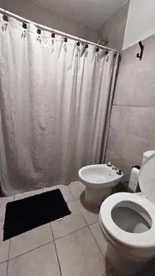 a bathroom with a toilet and a shower and a sink at CHACABUCO 1 dormitorio in Cordoba